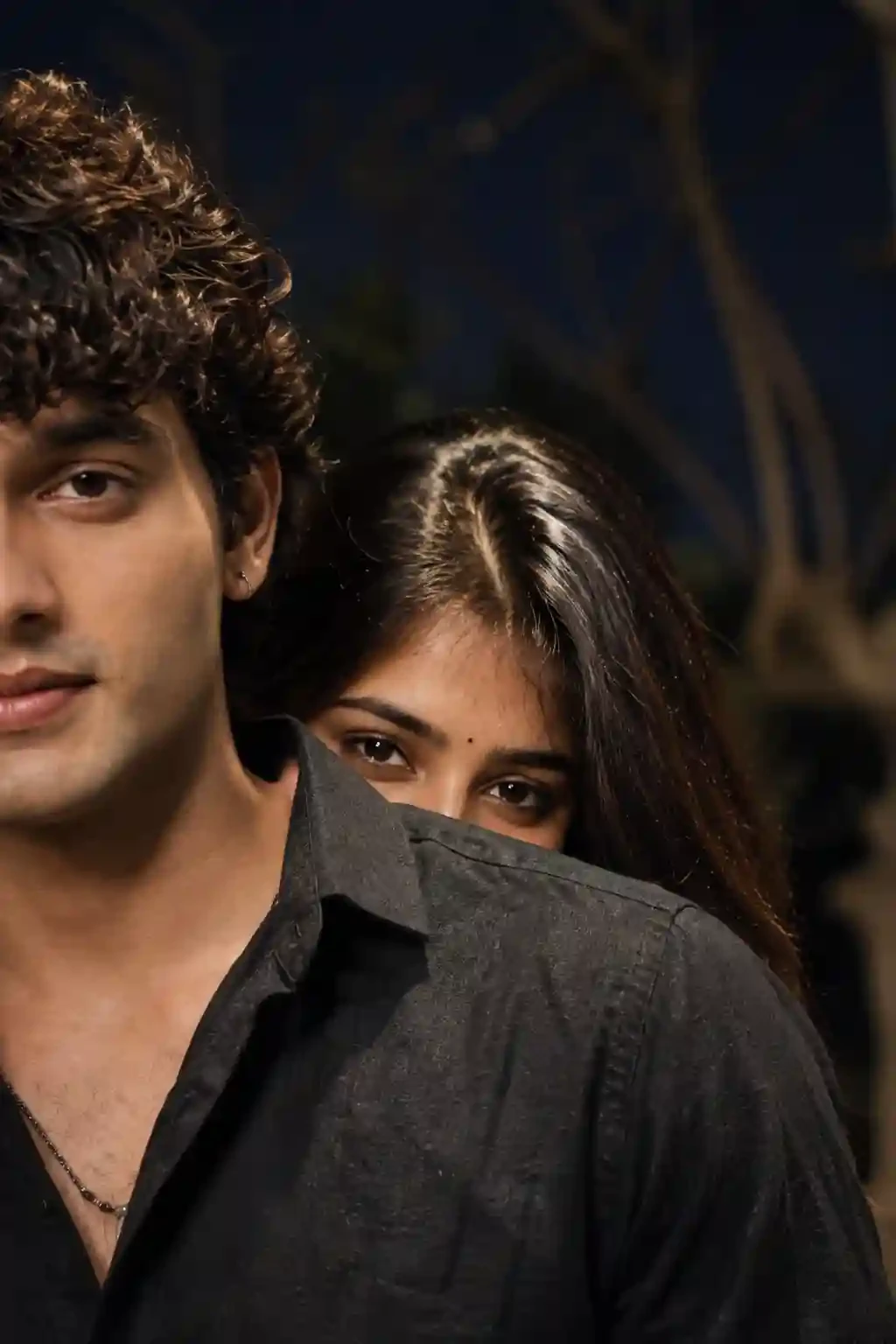 Moody night curly hair couple gaze black shirt prompt for Gemini and ChatGPT